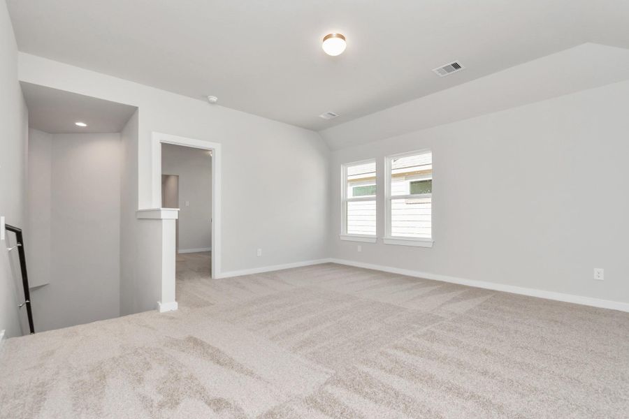 Come upstairs and relish a day of relaxation in this loft area! Ideal as an additional living space or game room, it boasts plush carpeting, high ceilings, custom paint, and windows that flood the area with abundant natural light. Sample photo of completed home with similar floor plan. Actual colors and selections may vary. Come upstairs and relish a day of relaxation in this loft area! Ideal as an additional living space or game room, it boasts plush carpeting, high ceilings, custom paint, and windows that flood the area with abundant natural light. Sample photo of completed home with similar floor plan. Actual colors and selections may vary.