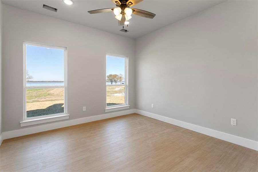 Unfurnished room featuring light hardwood / wood-style flooring and ceiling fan