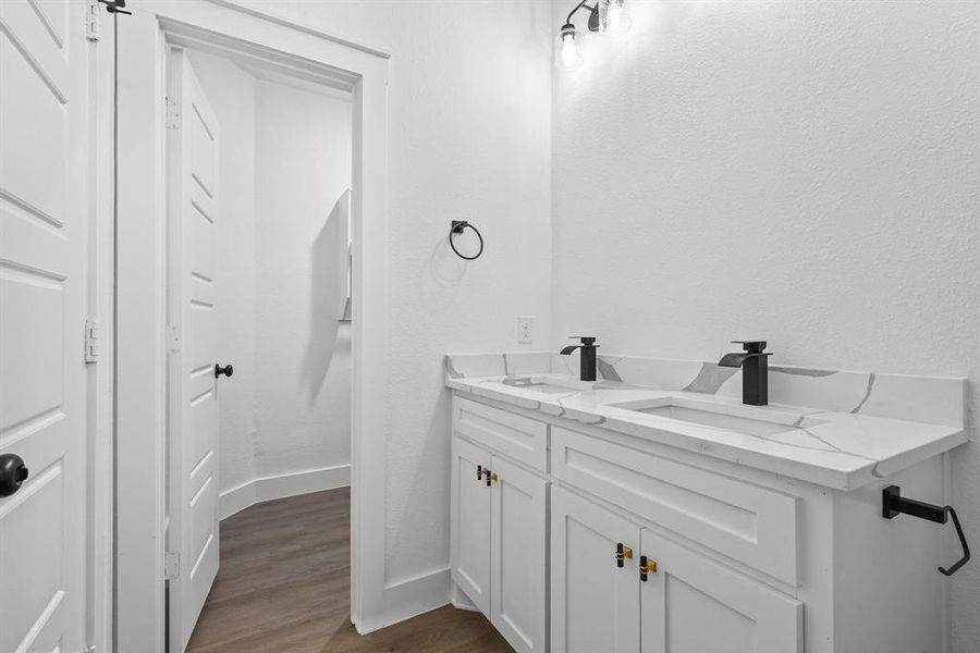 Bathroom with vanity and hardwood / wood-style floors