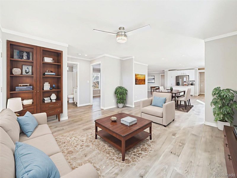Virtually Staged Living Room – Stylishly staged to inspire, this family room offers abundant natural light and a seamless connection to kitchen and hallway spaces.