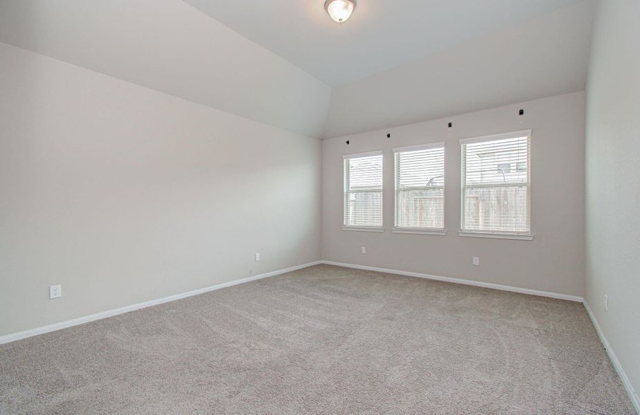 Spacious primary bedroom with upgraded triple-windows with upgraded faux wood blinds, all very nice.