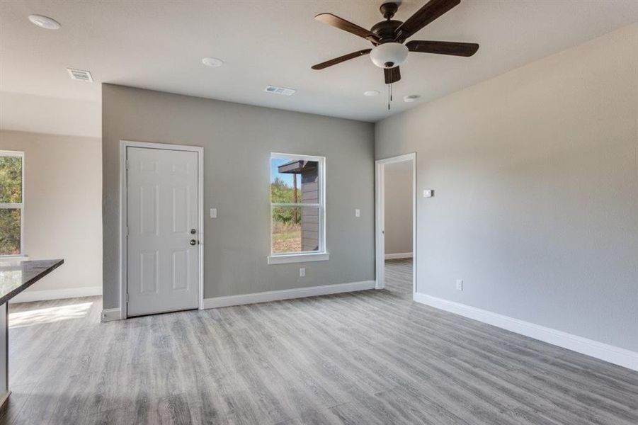 Unfurnished room with light wood-style floors, ceiling fan, and recessed lighting