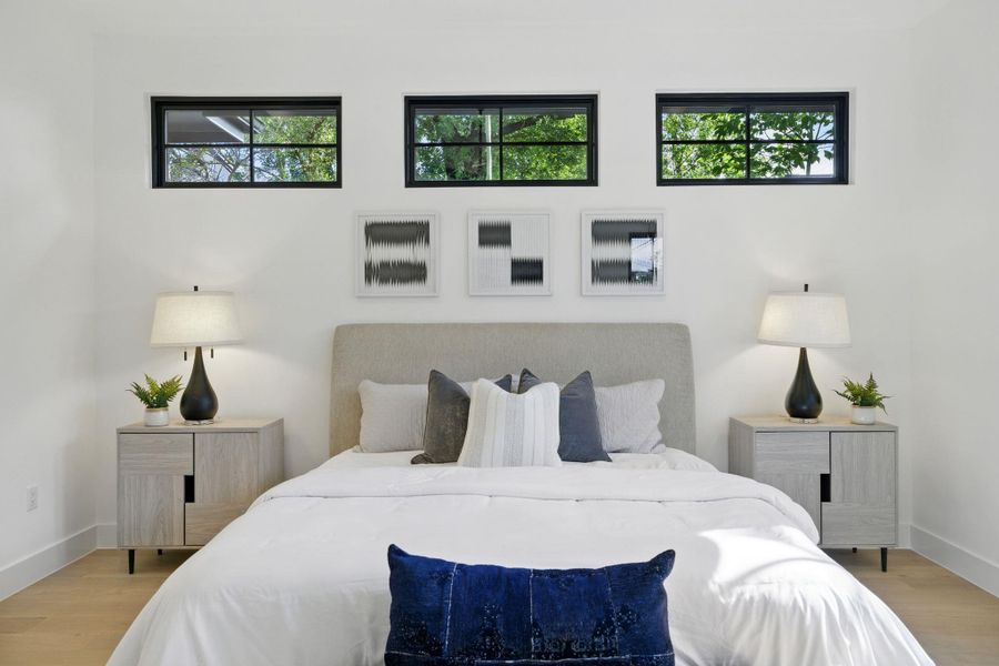 Bedroom with wood finished floors and baseboards