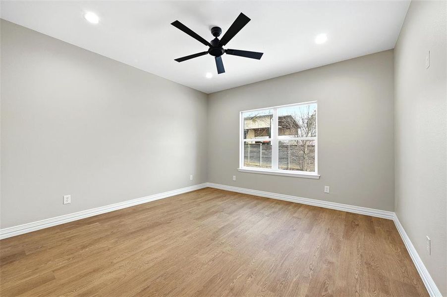 Unfurnished room with light wood-type flooring, a ceiling fan, and recessed lighting Unfurnished room with light wood-type flooring, a ceiling fan, and recessed lighting