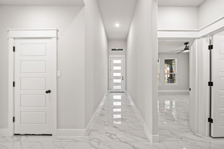 Corridor with recessed lighting and light marble finish flooring