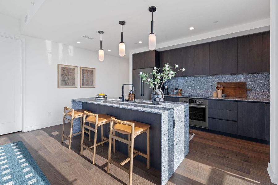 Representative Photo. The residence features the Industrial Rainey scheme which includes Italkraft carbon marine wood Italian cabinetry and terrazzo-quartz countertops, and Bosch stainless steel appliances.