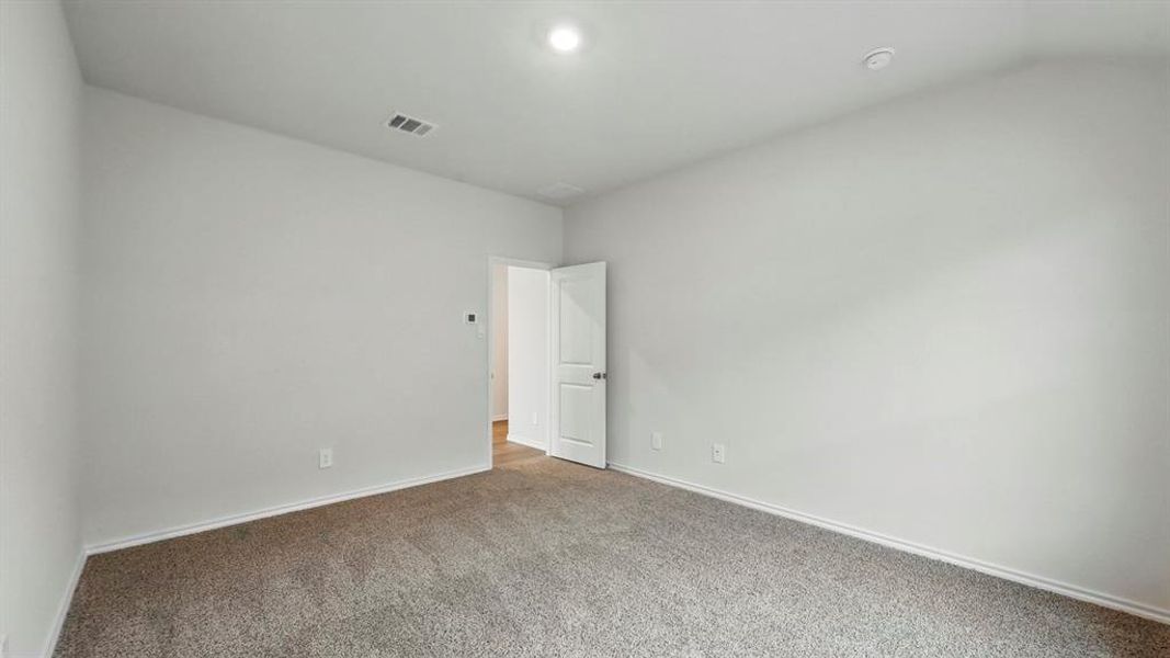 The room features a neutral color palette with light-colored walls and grey carpet flooring