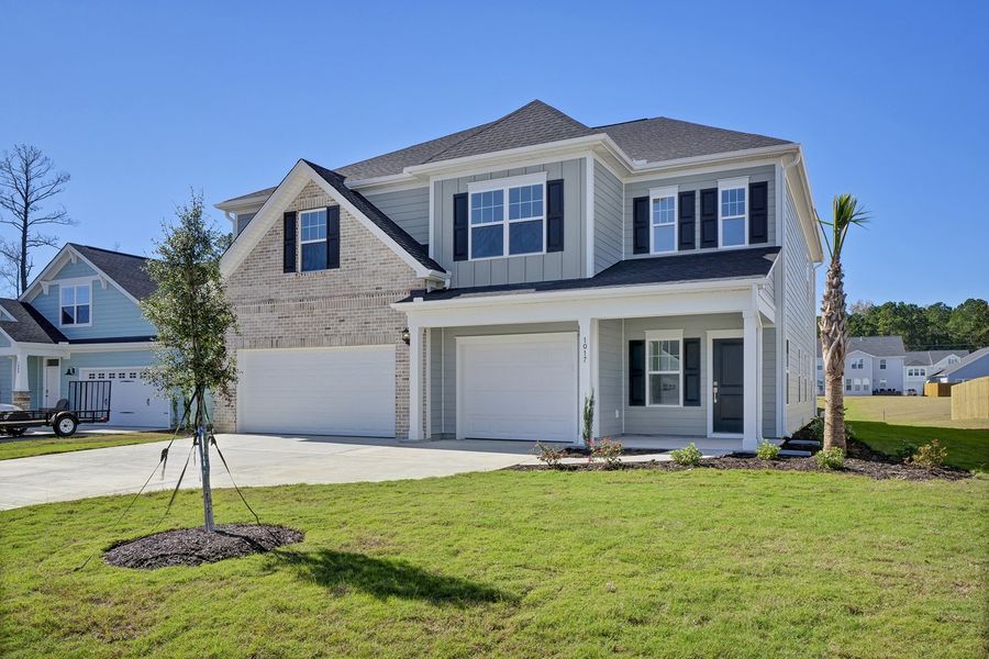 Front exterior of a new home in Grand Park, Leland, NC, highlighting curb appeal (Image 2).