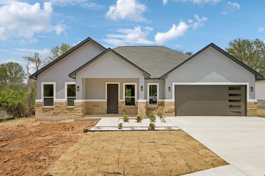 Front exterior of a new home in , Bastrop, TX, highlighting curb appeal (Image 21).