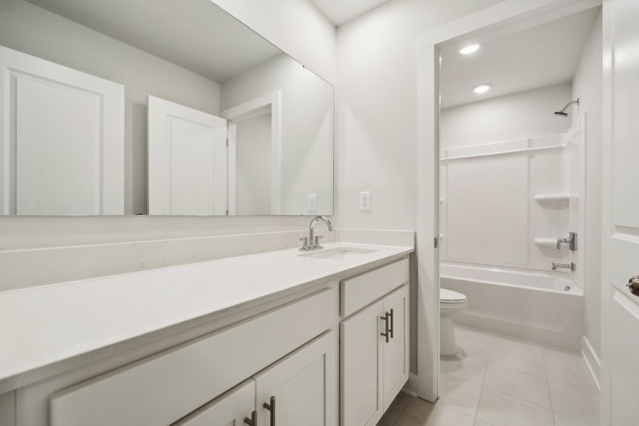 A bathroom with white cabinets. A bathroom with white cabinets.