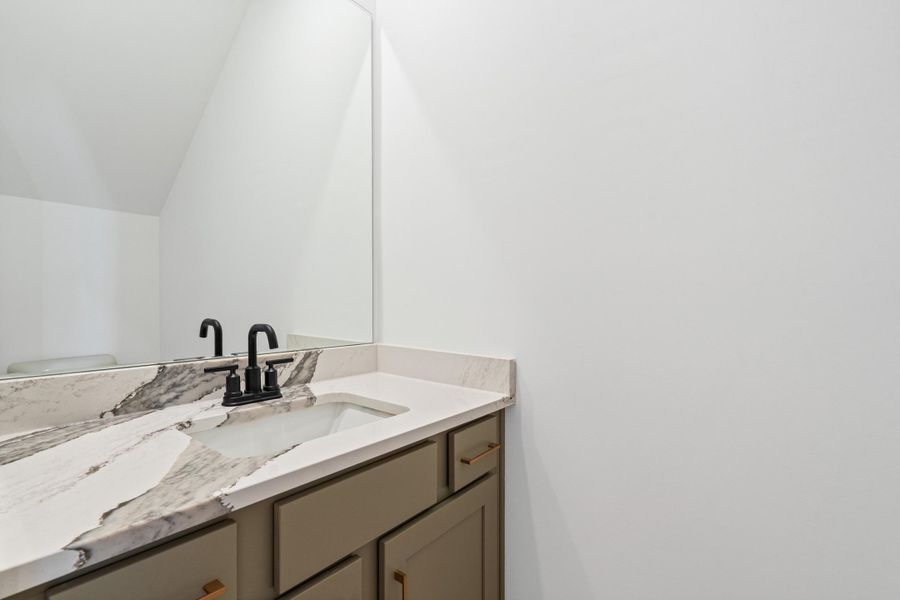 Vanity with a two-tone countertop, an undermount sink, and a matte black faucet Vanity with a two-tone countertop, an undermount sink, and a matte black faucet
