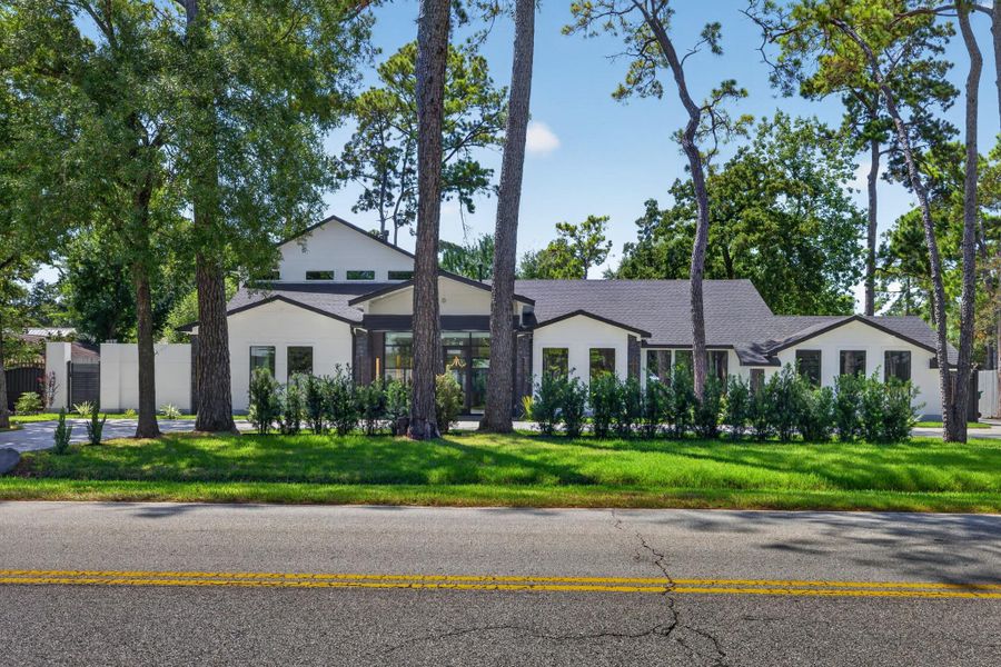 The home’s impressive frontage, mature trees and established setting.