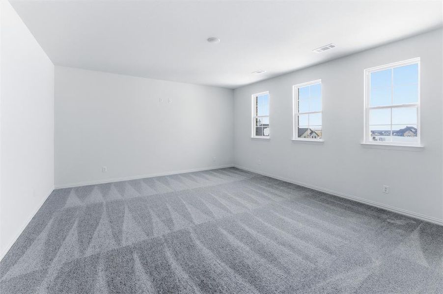 Spare room featuring carpet and baseboards