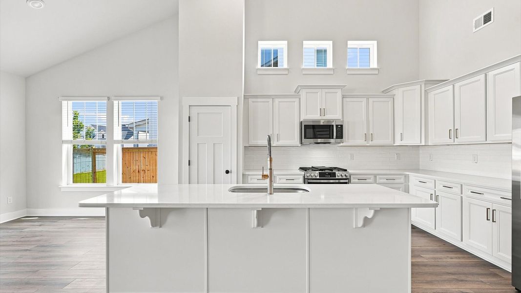 Highly skilled design choices create a clean, open kitchen with a central island Highly skilled design choices create a clean, open kitchen with a central island