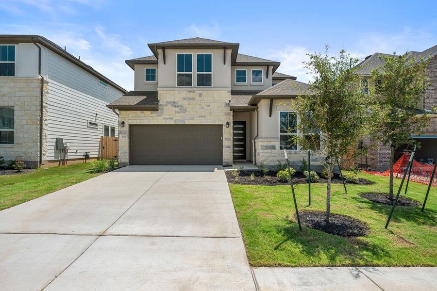 Front exterior of a new home in Lagos Reserve, Manor, TX, highlighting curb appeal (Image 2). Front exterior of a new home in Lagos Reserve, Manor, TX, highlighting curb appeal (Image 2).