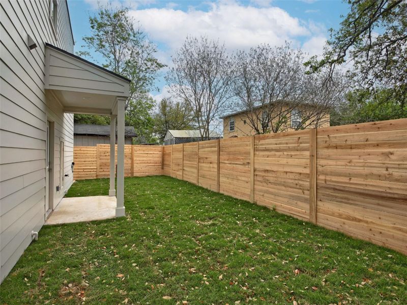 Fenced backyard featuring a patio