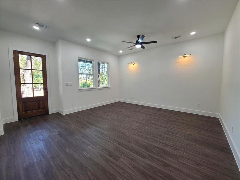 Unfurnished room with ceiling fan and dark hardwood / wood-style floors