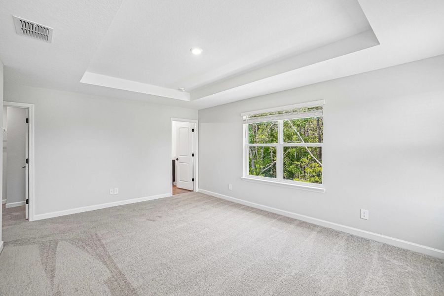 The primary bedroom has a beautiful treed view The primary bedroom has a beautiful treed view