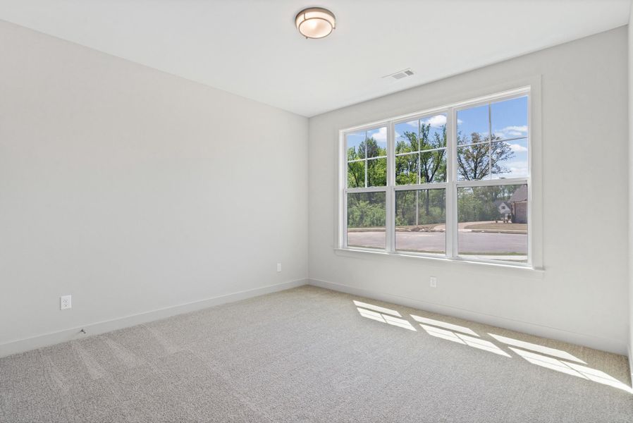 Empty room with light carpet and baseboards