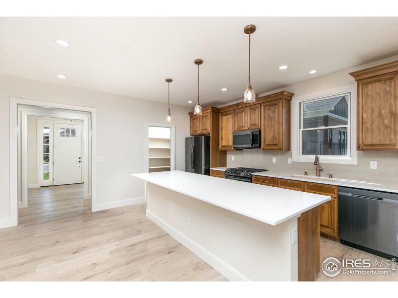 The kitchen features a large island and lots of counter space and cabinets