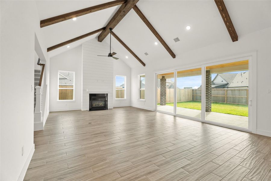 Impressive dining area and great room with fireplace and 15' sliding glass doors (*Photo not of actual home and used for illustration purposes only.)