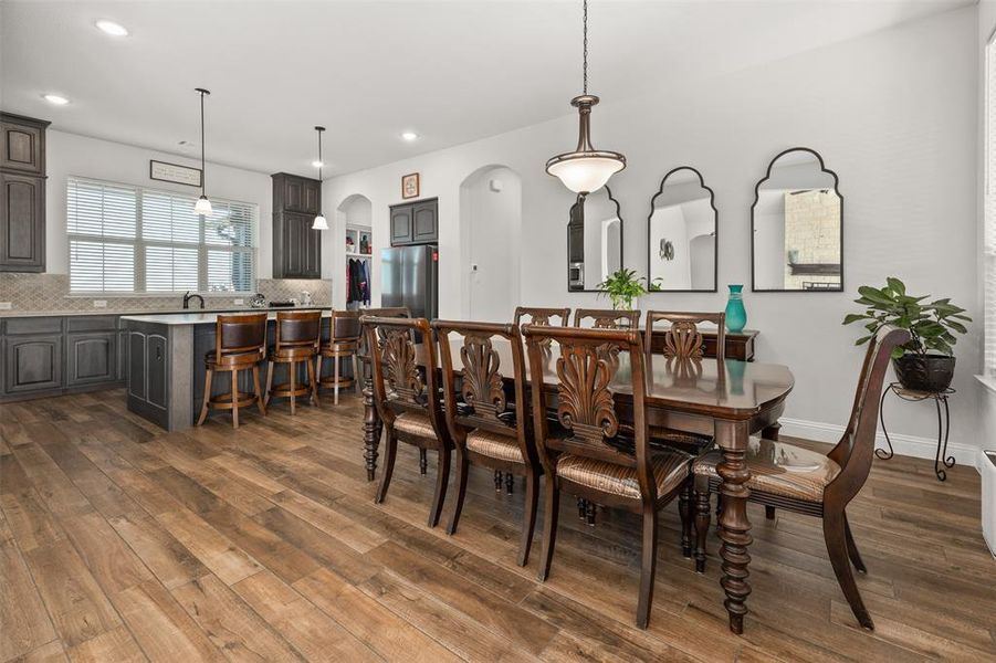 Dining room featuring sink and dark hardwood / wood-style flooring Dining room featuring sink and dark hardwood / wood-style flooring
