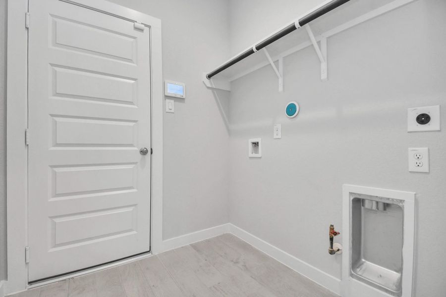 A perfect blend of functionality and comfort. Capture the essence of easy living with a first-floor laundry room, thoughtfully equipped with shelving for effortless organization. Both electric and gas connections available.