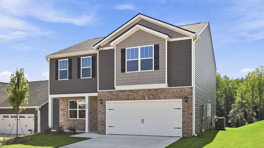 Front exterior of a new home in Sherwood Gardens, Landrum, SC, highlighting curb appeal (Image 2). Front exterior of a new home in Sherwood Gardens, Landrum, SC, highlighting curb appeal (Image 2).