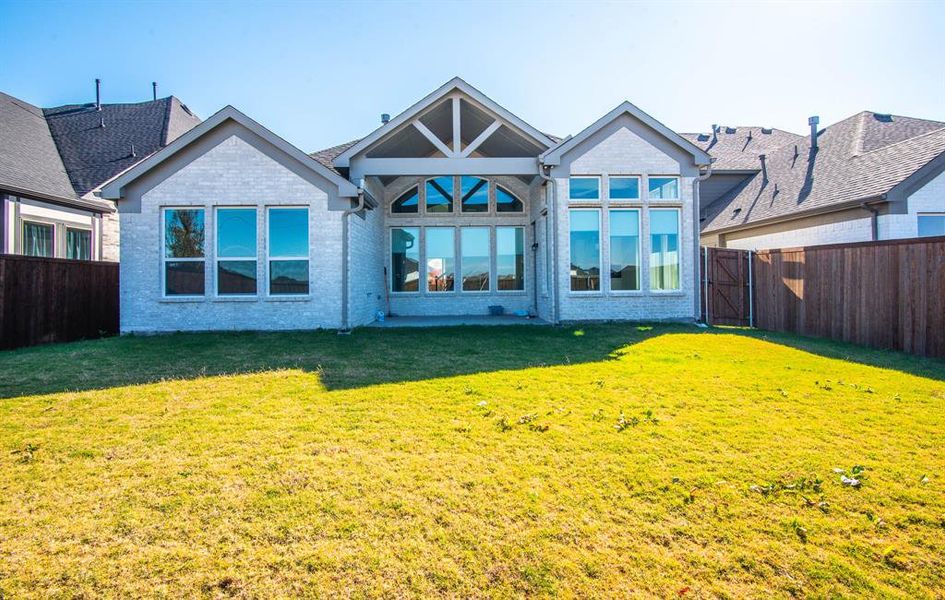 Rear view of property featuring a lawn