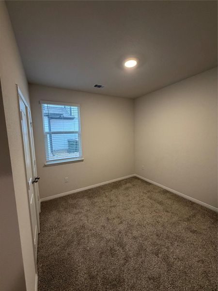 Empty room with carpet and baseboards