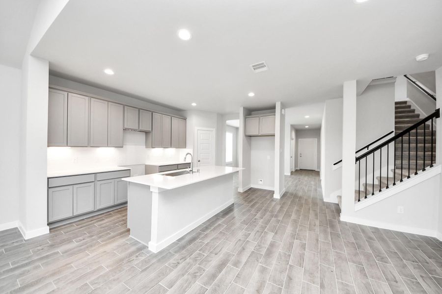 This kitchen is by far any chef’s dream! This spacious kitchen features high ceilings, light stained wood cabinets, granite countertop, SS appliances, modern tile backsplash, recessed lighting, extended counter space, granite kitchen island with double sink, and space for breakfast bar, and a walk-in pantry all overlooking your huge family room. This kitchen is by far any chef’s dream! This spacious kitchen features high ceilings, light stained wood cabinets, granite countertop, SS appliances, modern tile backsplash, recessed lighting, extended counter space, granite kitchen island with double sink, and space for breakfast bar, and a walk-in pantry all overlooking your huge family room.