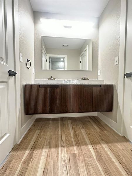 Bathroom with hardwood / wood-style flooring and vanity