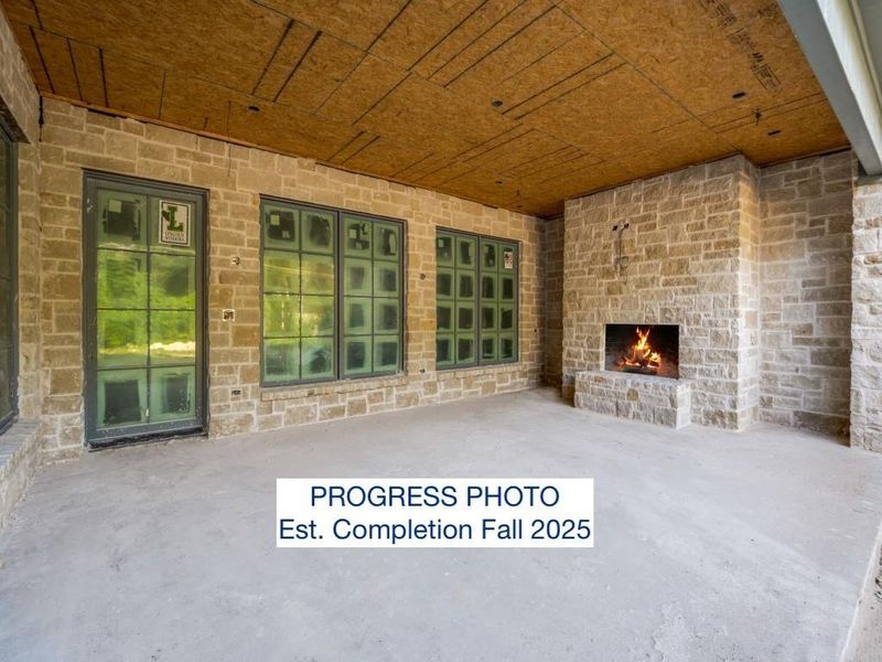 Progress Photo, rear patio and fireplace. Estimated Completion Fall 2025.
