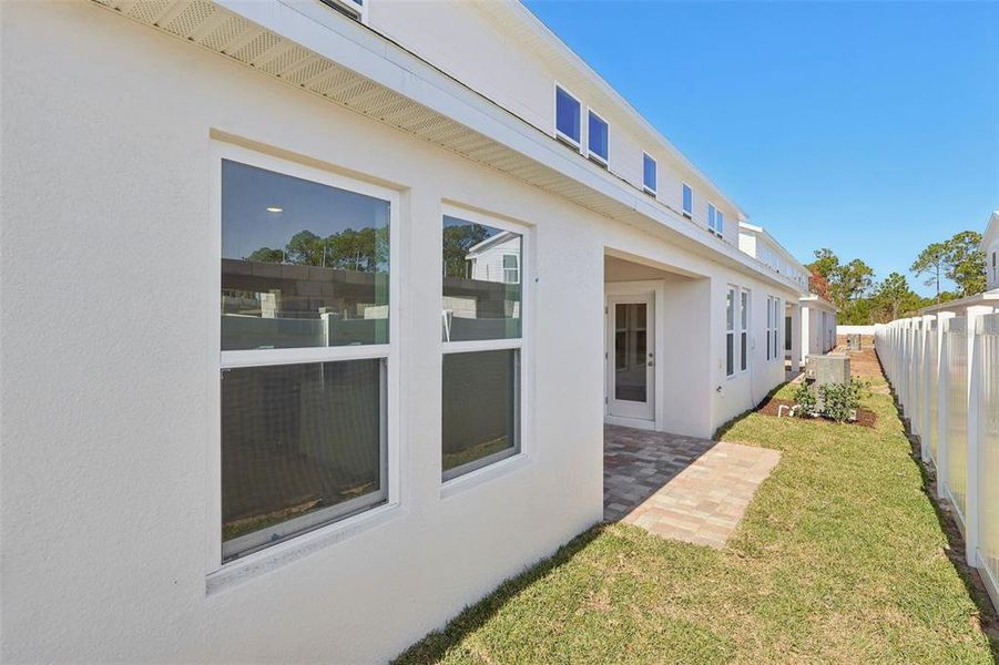 Exterior details and patio area of a home in Cyrene at Harmony, St. Cloud (Image 21).