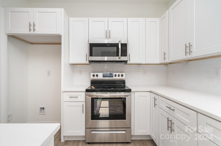 Representative Photo. Electric oven with mounted microwave