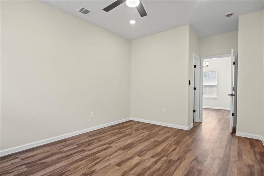 Spare room featuring dark wood-style floors, recessed lighting, and a ceiling fan Spare room featuring dark wood-style floors, recessed lighting, and a ceiling fan