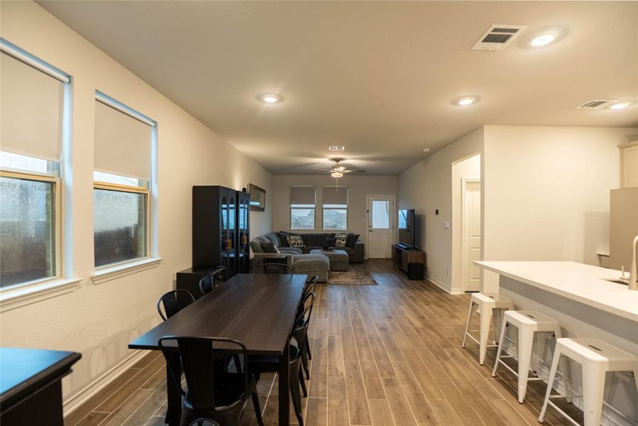 Dining space featuring wood finish floors, recessed lighting, and ceiling fan Dining space featuring wood finish floors, recessed lighting, and ceiling fan