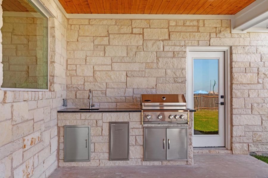 View of patio / terrace featuring a sink and exterior kitchen View of patio / terrace featuring a sink and exterior kitchen