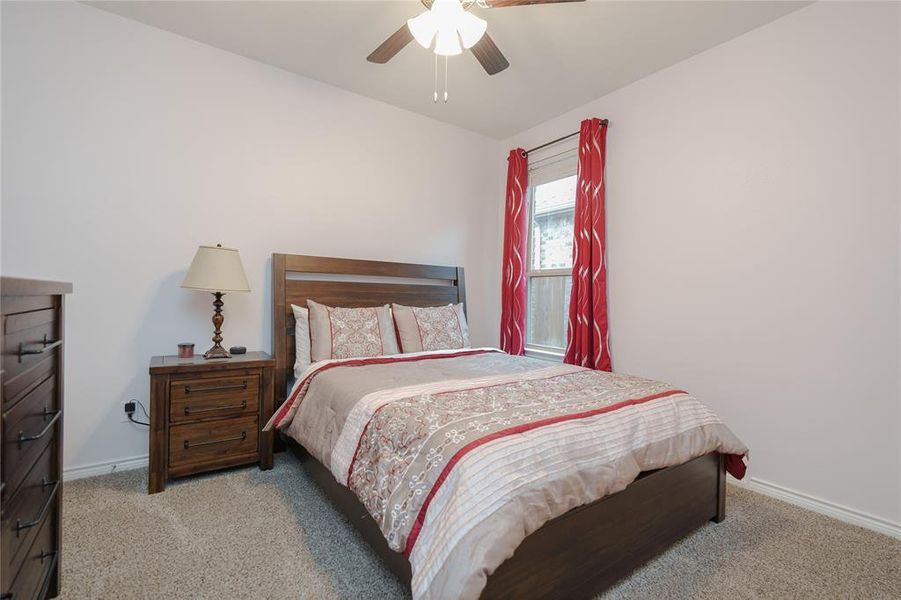 Bedroom featuring ceiling fan and light colored carpet