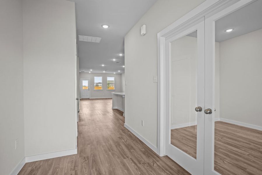 A hallway with white doors. A hallway with white doors.