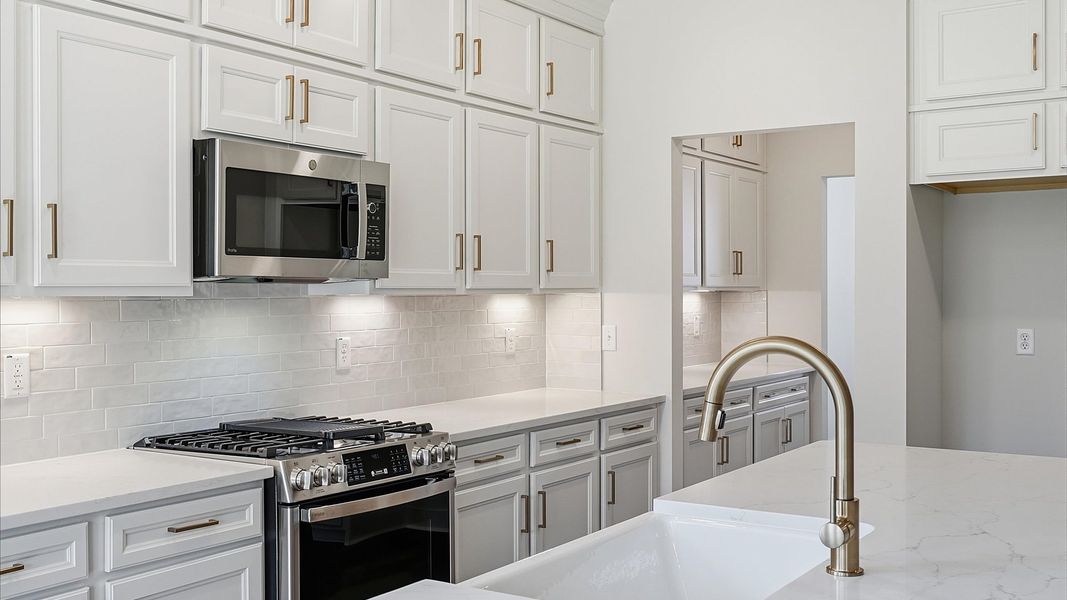 Elegant center island anchors this tasteful kitchen with high standards and timeless appeal at the Benjamin's Grove community Elegant center island anchors this tasteful kitchen with high standards and timeless appeal at the Benjamin's Grove community