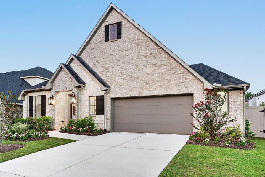 Front exterior of a new home in Audubon 60′, Magnolia, TX, highlighting curb appeal (Image 1). Front exterior of a new home in Audubon 60′, Magnolia, TX, highlighting curb appeal (Image 1).