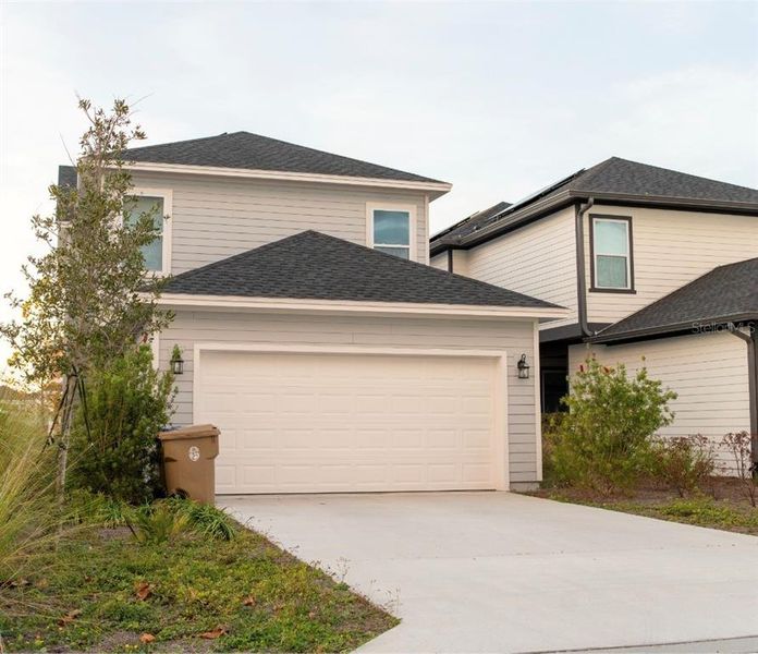 Front exterior of a new home in Weslyn Park in Sunbridge 34', St. Cloud, FL, highlighting curb appeal (Image 27).