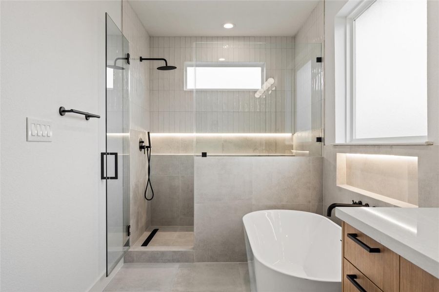 Another angle of the spa-style bath highlighting the glass shower and elegant finishes.
