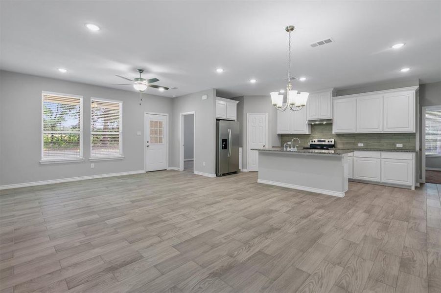 View of living area and kitchen.