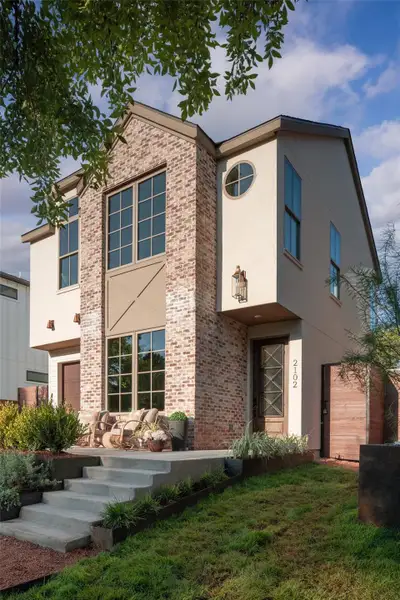 Clean lines and classic brickwork define this modern multi-level residence with concrete entry steps. Clean lines and classic brickwork define this modern multi-level residence with concrete entry steps.