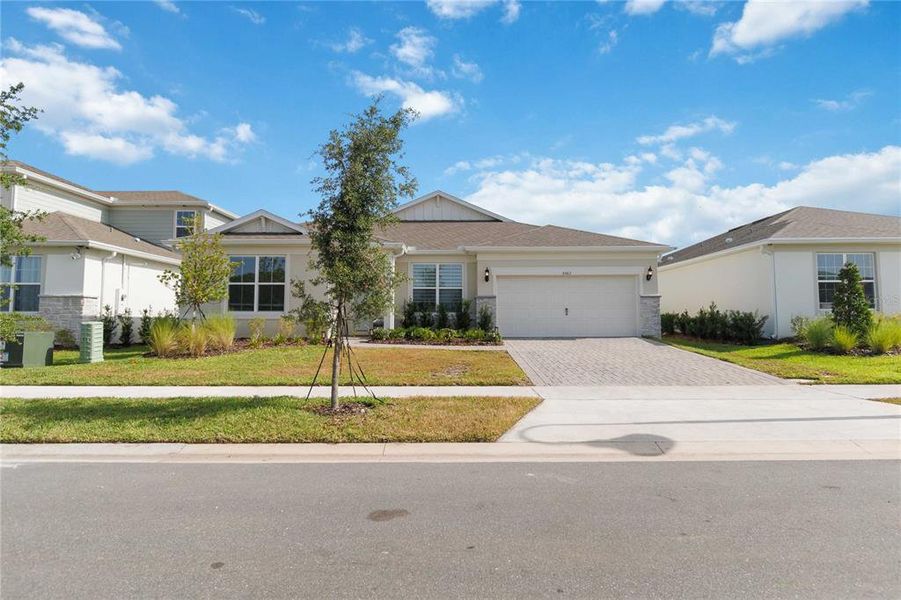 Front exterior of a new home in Bridgewalk, St. Cloud, FL, highlighting curb appeal (Image 25). Front exterior of a new home in Bridgewalk, St. Cloud, FL, highlighting curb appeal (Image 25).