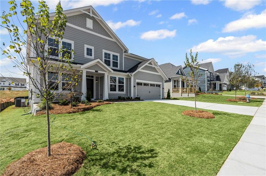 Front exterior of a new home in Twin Lakes, Hoschton, GA, highlighting curb appeal (Image 20). Front exterior of a new home in Twin Lakes, Hoschton, GA, highlighting curb appeal (Image 20).