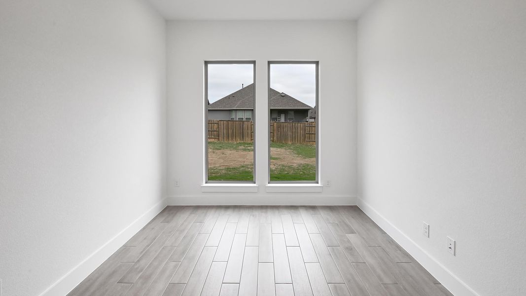 Unfurnished room with baseboards and light wood-type flooring