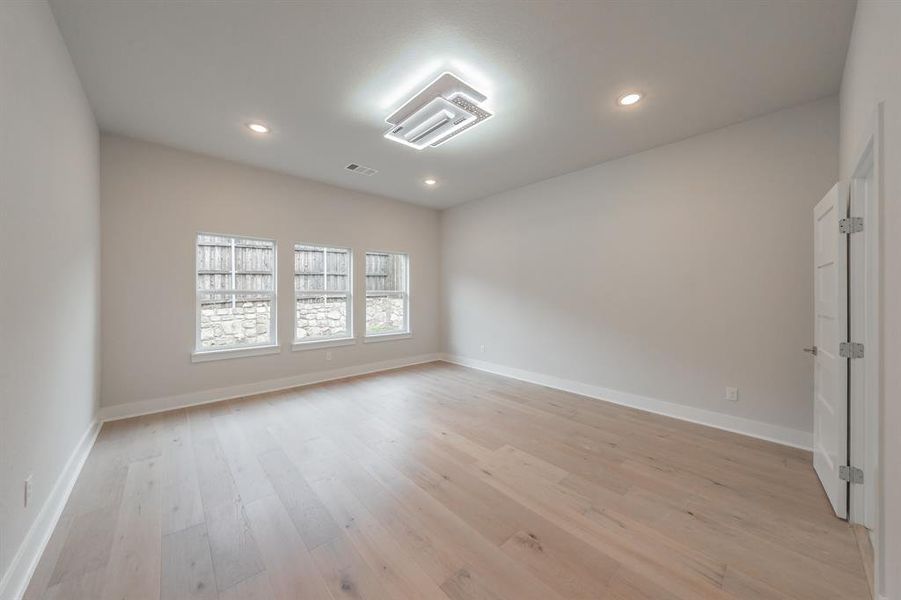 Spare room featuring light wood finished floors and recessed lighting